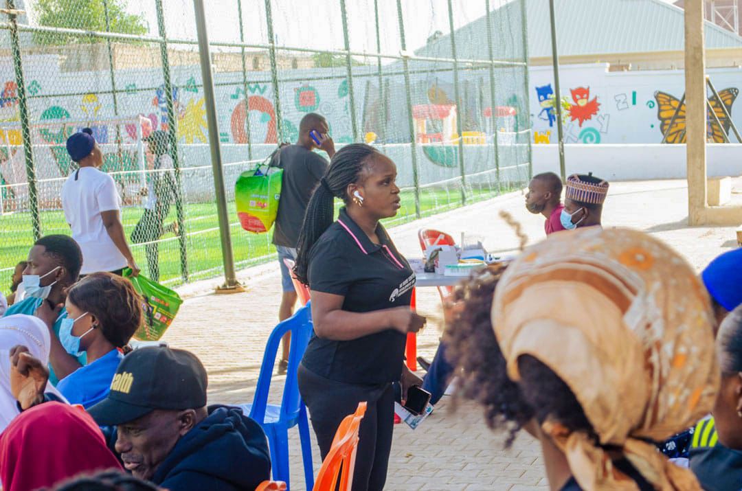 Staff member speaking with attendees at an outreach table