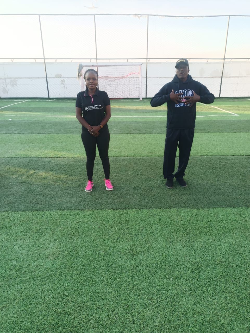 Two facilitators standing on the field
